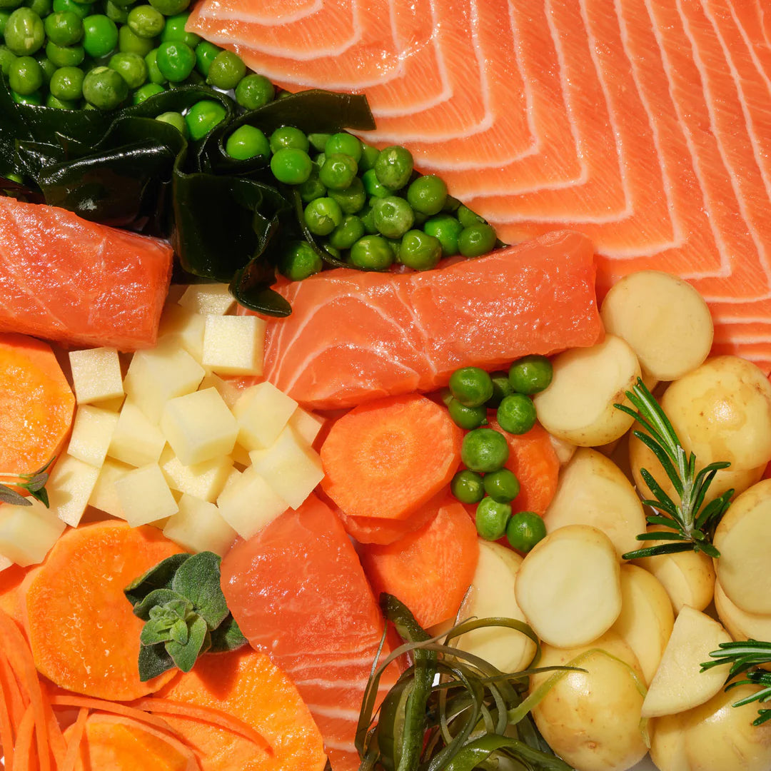 Platter of salmon, vegetables, and potatoes with green peas and seaweed.